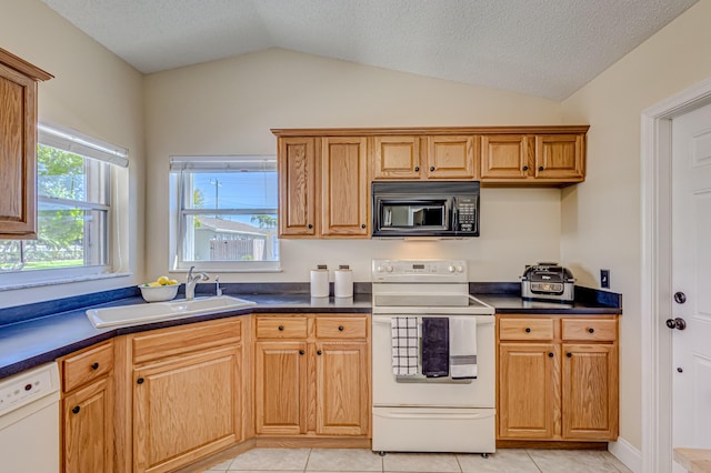 kitchen with sink, a textured ceiling, vaulted ceiling, white appliances, and light tile patterned flooring