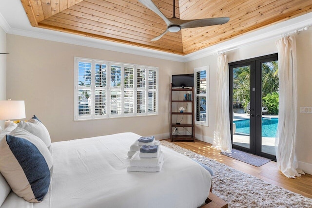 bedroom with access to exterior, french doors, a tray ceiling, and wooden ceiling