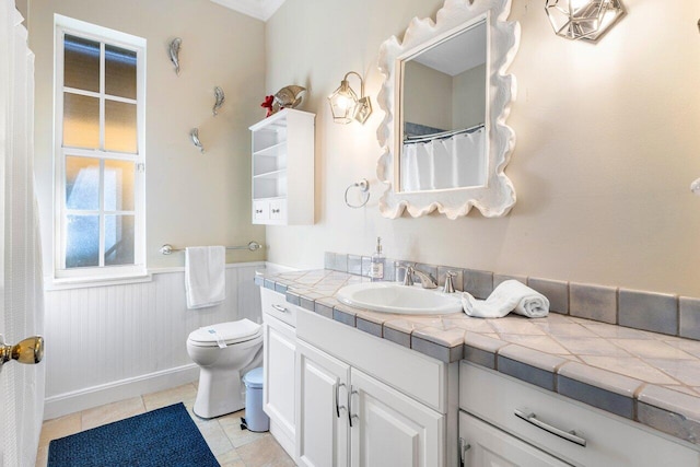 bathroom featuring tile patterned floors, vanity, and toilet