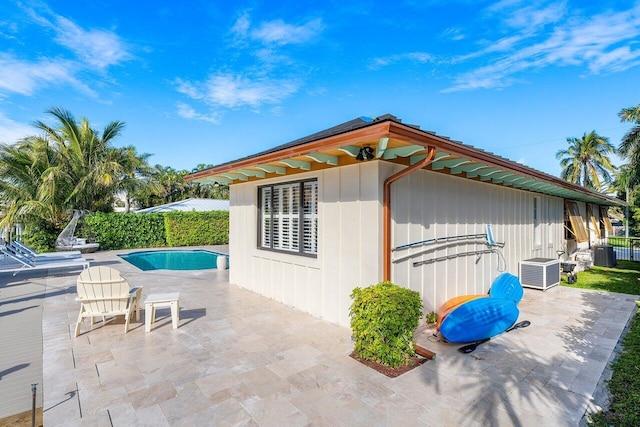 view of home's exterior with a fenced in pool, a patio area, and central air condition unit