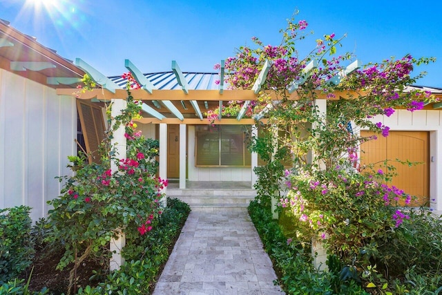 doorway to property with a pergola