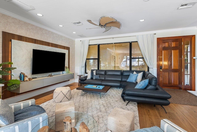 living room with ceiling fan, wood-type flooring, and crown molding