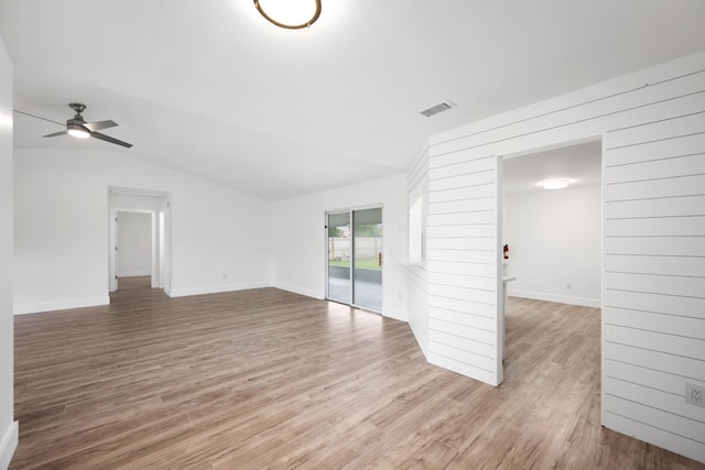 unfurnished living room with ceiling fan, lofted ceiling, and light hardwood / wood-style flooring