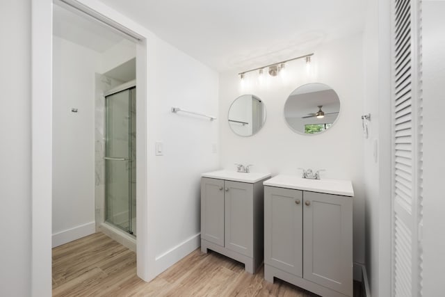 bathroom with walk in shower, hardwood / wood-style flooring, and ceiling fan