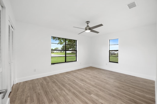 unfurnished bedroom featuring a closet, ceiling fan, and light hardwood / wood-style flooring