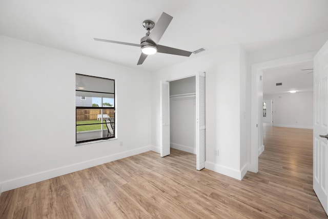 unfurnished bedroom featuring a closet, light hardwood / wood-style flooring, and ceiling fan