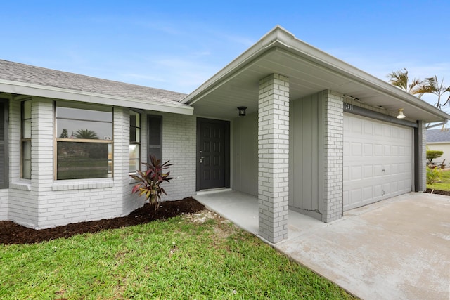 doorway to property with a garage