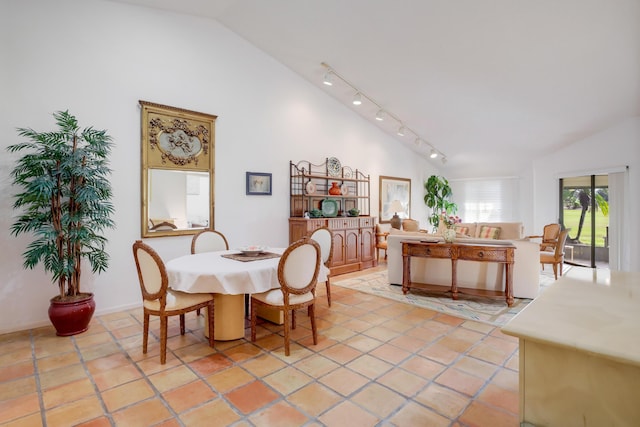 tiled dining space with vaulted ceiling