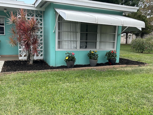 view of property exterior with a yard
