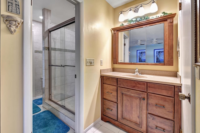 bathroom featuring walk in shower, vanity, and tile patterned flooring