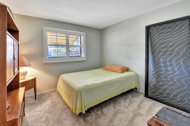 bedroom featuring light colored carpet