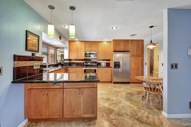 kitchen with appliances with stainless steel finishes, sink, decorative backsplash, hanging light fixtures, and kitchen peninsula