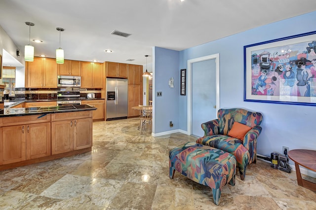 kitchen with tasteful backsplash, appliances with stainless steel finishes, and decorative light fixtures