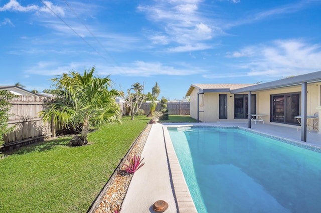 view of swimming pool with a yard and a patio