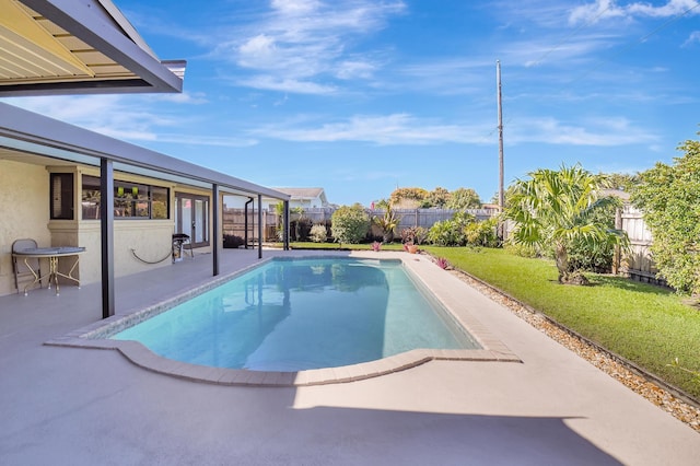 view of swimming pool with a patio and a yard