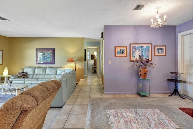 tiled living room featuring a textured ceiling and a notable chandelier