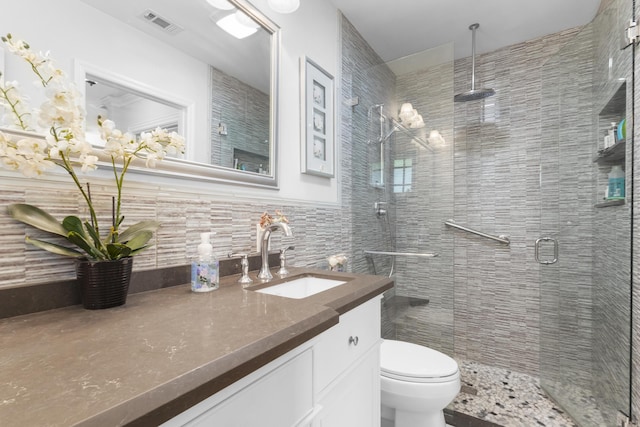 bathroom featuring vanity, toilet, an enclosed shower, and tile walls