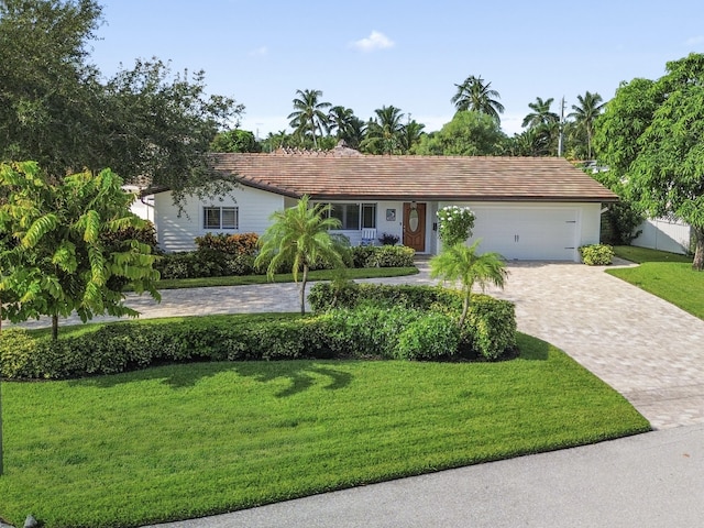 ranch-style house with a front yard and a garage