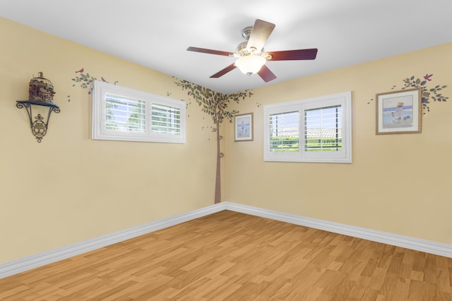 empty room featuring ceiling fan and light hardwood / wood-style floors