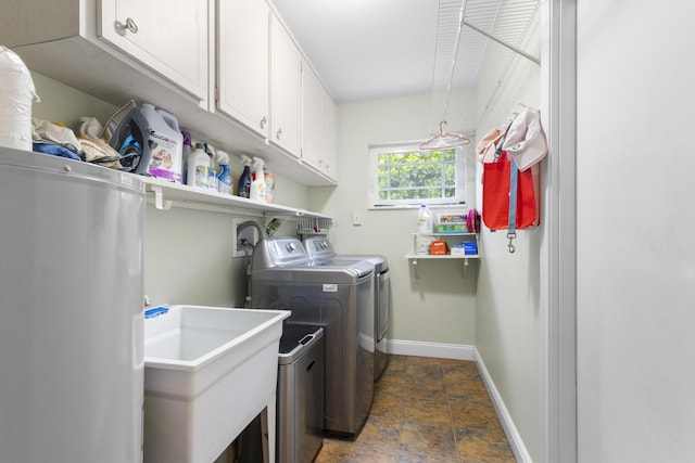 laundry room with cabinets, independent washer and dryer, and sink