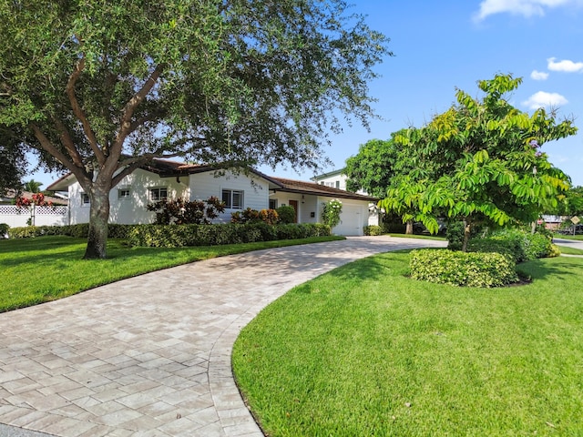 view of front of house featuring a front yard and a garage