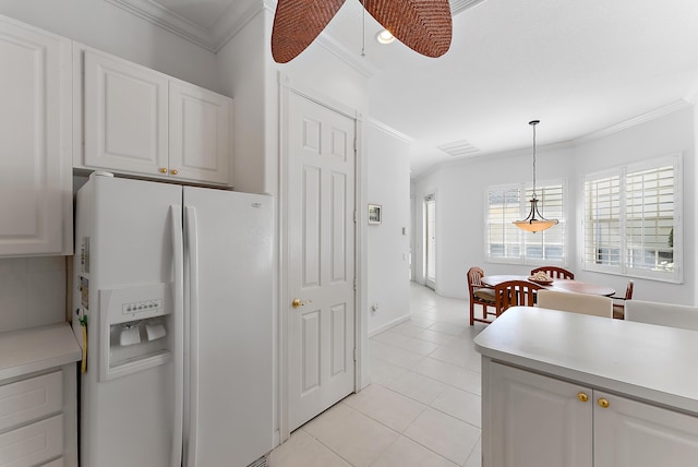 kitchen featuring decorative light fixtures, white cabinetry, and white refrigerator with ice dispenser