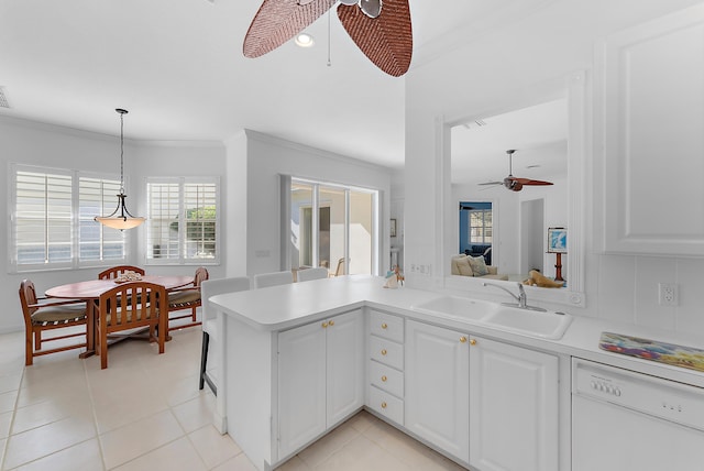 kitchen with white dishwasher, white cabinets, sink, ceiling fan, and kitchen peninsula