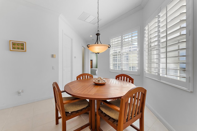 dining room featuring light tile patterned floors and ornamental molding