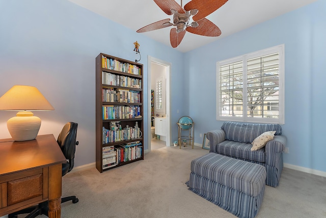 carpeted home office featuring ceiling fan