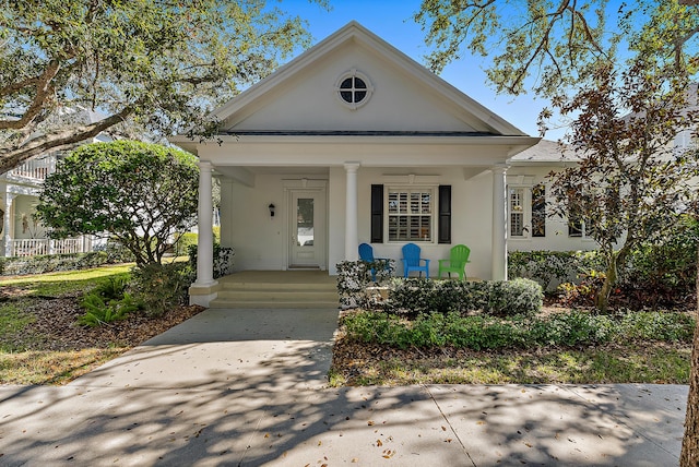 neoclassical / greek revival house featuring covered porch