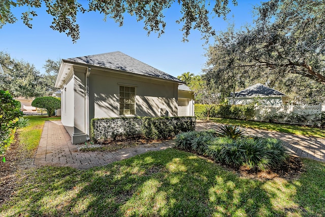 view of side of property with a yard and a garage