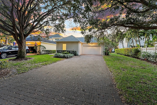 view of front of property featuring a garage and a front yard