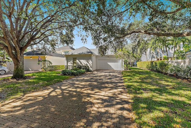 view of front of house featuring a garage and a front lawn