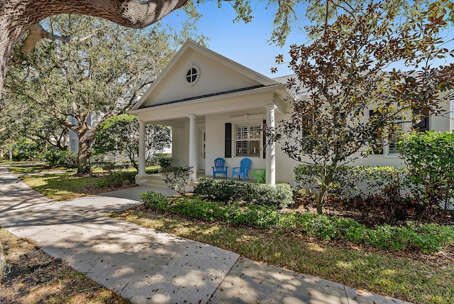 greek revival house featuring covered porch