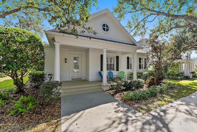 neoclassical home featuring a porch