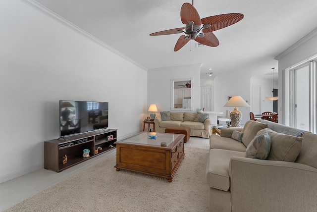 living room featuring ceiling fan, light tile patterned flooring, and ornamental molding