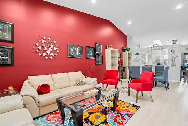 living room featuring hardwood / wood-style flooring and high vaulted ceiling