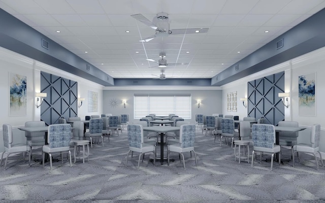 carpeted dining space featuring a paneled ceiling and ceiling fan