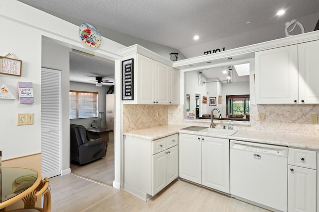 kitchen featuring a textured ceiling, ceiling fan, sink, dishwasher, and white cabinetry