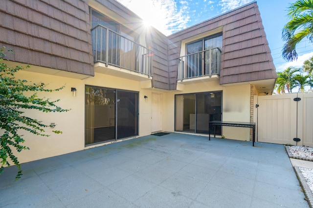 rear view of property featuring a patio area