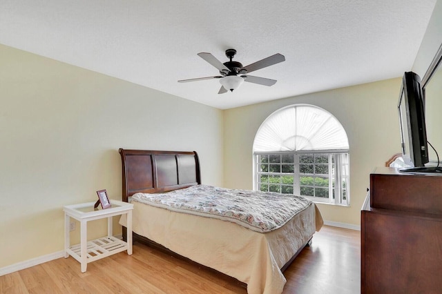 bedroom with ceiling fan and wood-type flooring