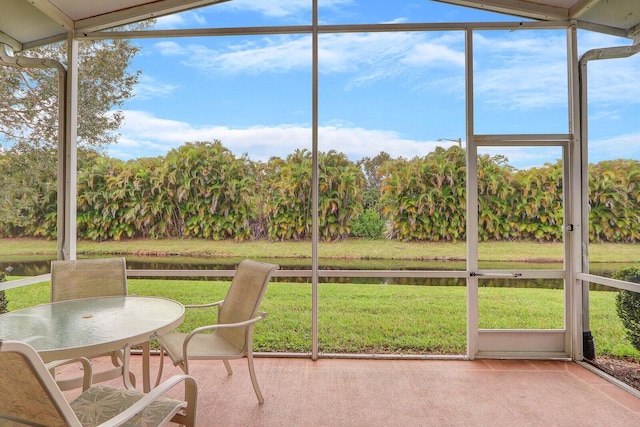 unfurnished sunroom featuring a water view