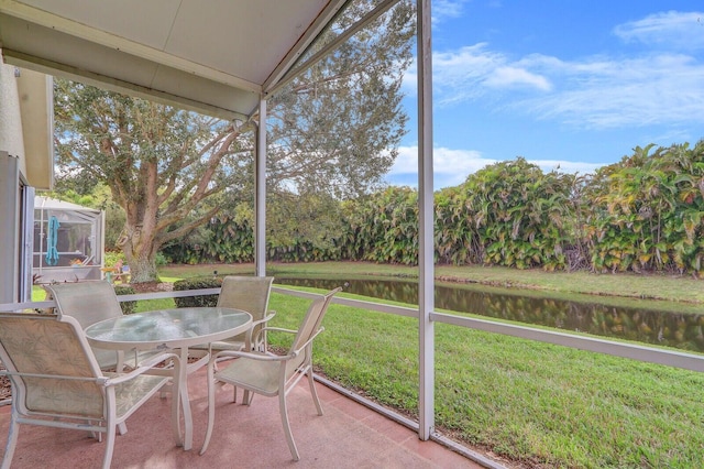 sunroom with a healthy amount of sunlight and a water view