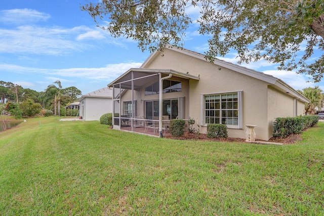 rear view of property featuring a lawn