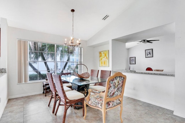 tiled dining room with ceiling fan with notable chandelier and vaulted ceiling