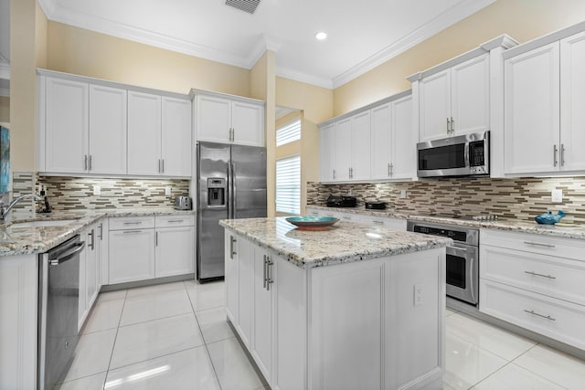 kitchen featuring a kitchen island, sink, white cabinets, and black appliances