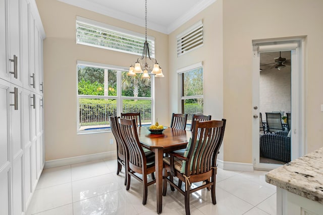 tiled dining area featuring ceiling fan with notable chandelier and ornamental molding