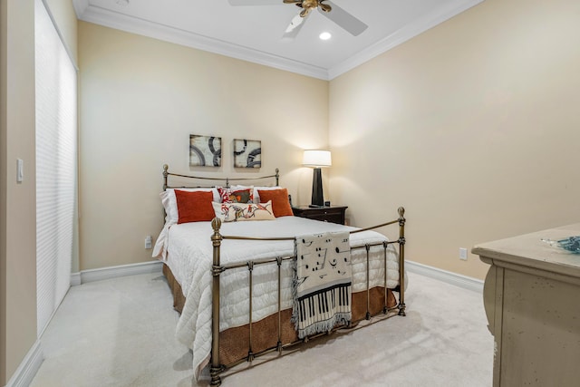 carpeted bedroom with ceiling fan and ornamental molding