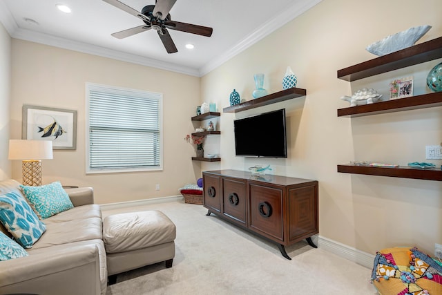 carpeted living room featuring ceiling fan and ornamental molding