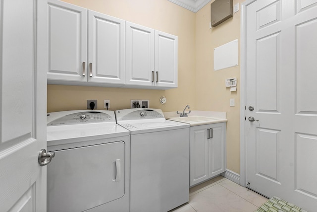 laundry area featuring light tile patterned flooring, crown molding, sink, separate washer and dryer, and cabinets